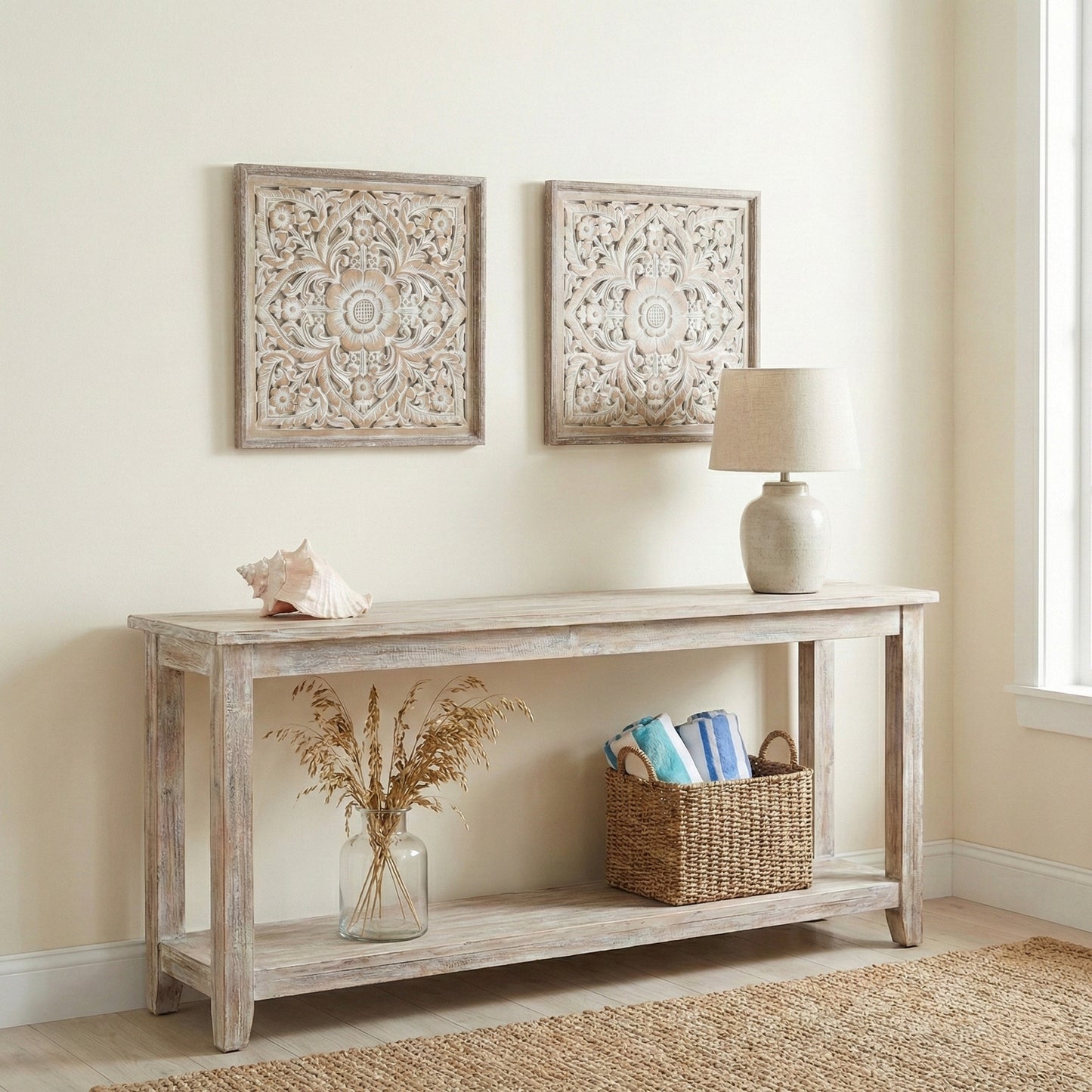 Wooden console table with decorative items against a beige wall with framed artwork.